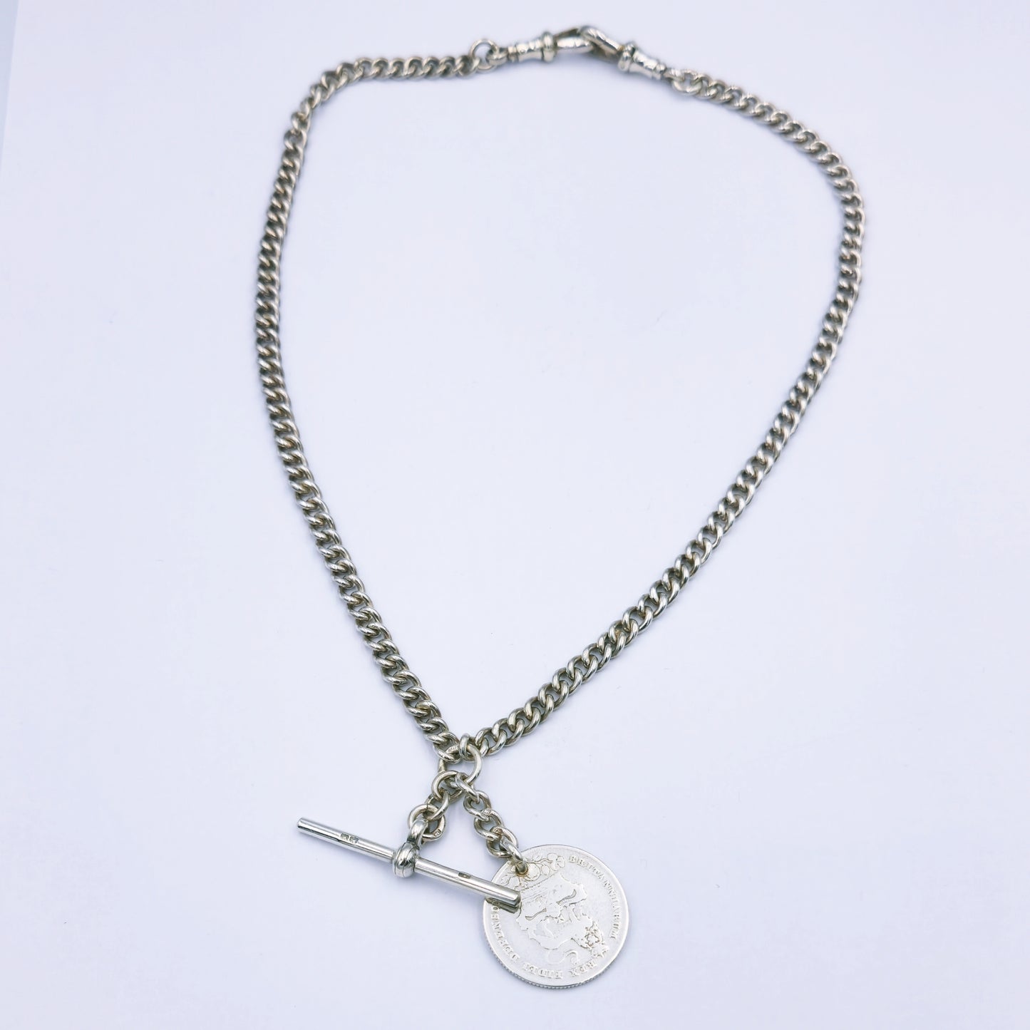 Antique sterling silver 43cm curb chain with stamped links, featuring two swivel clasps, a T-bar fob, and a 1826 Georgius IV Dei Gratia coin pendant; approx. 37.1g in weight