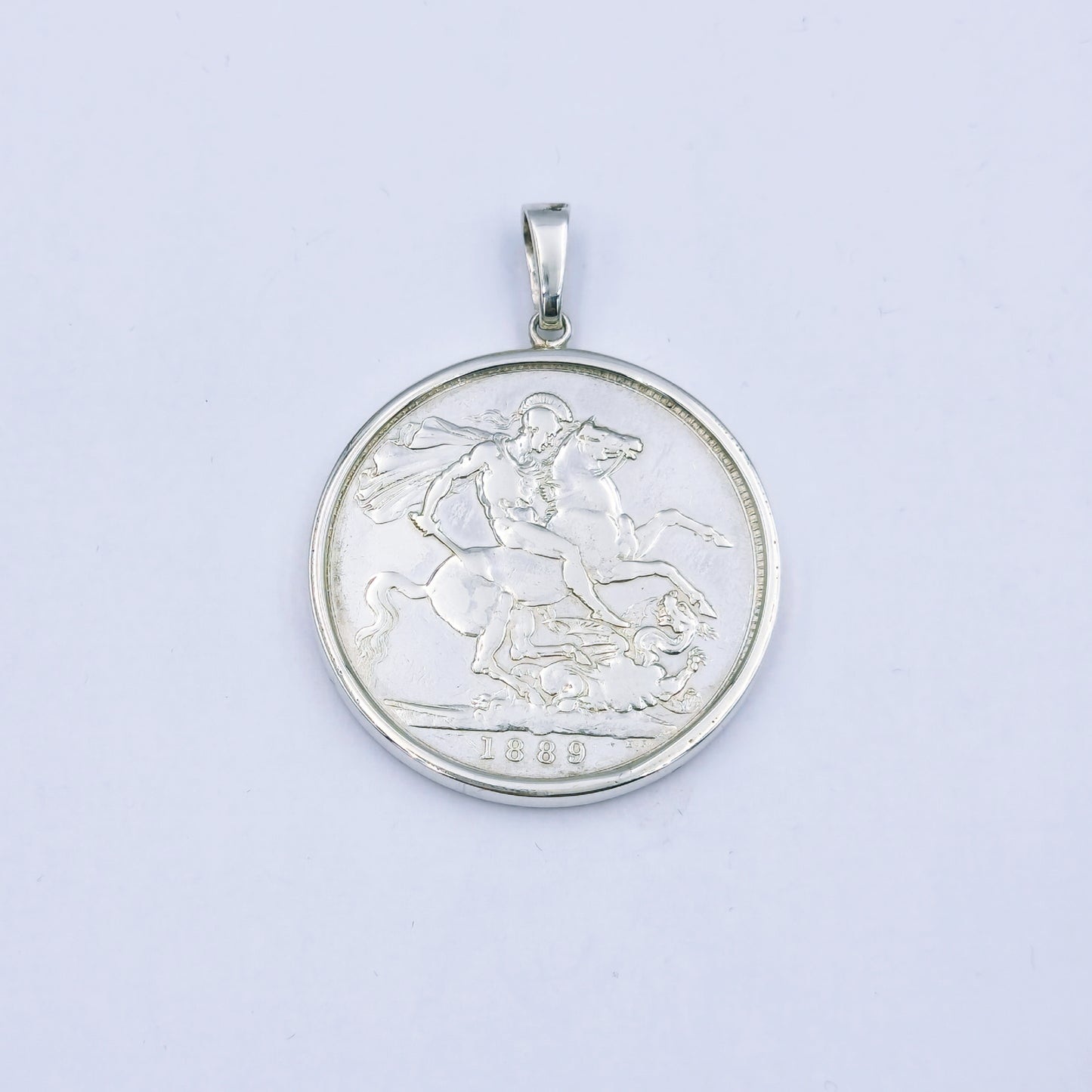 Sterling silver pendant featuring an 1889 Queen Victoria coin, set in a silver frame with a 4cm diameter loop, weighing approximately 32.1g