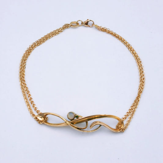 Restored Art Deco bracelet with 15ct rose gold panel set with a 3.5mm opal and 0.01ct emerald, attached to a delicate double strand 9ct rose gold chain; 19.5cm long, approx. 3.9g.