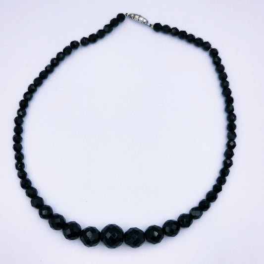 Vintage 43cm necklace with faceted black onyx beads tapering from 14mm to 5.5mm, finished with a vintage marcasite-accented clasp