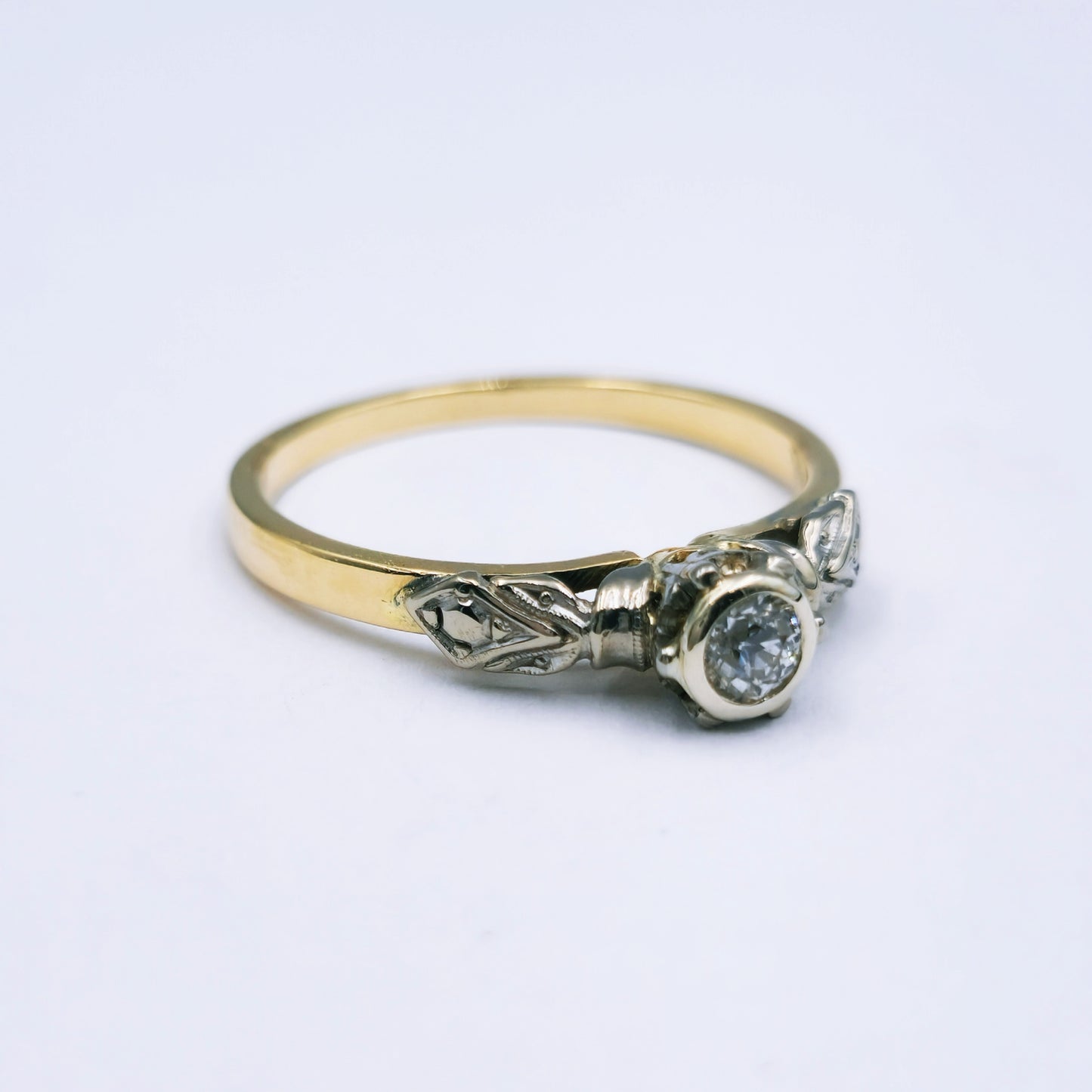Refurbished vintage 18ct yellow gold ring with a 0.17ct old cut diamond in a white gold-accented tube setting; size N, weighing approx. 2.7g.