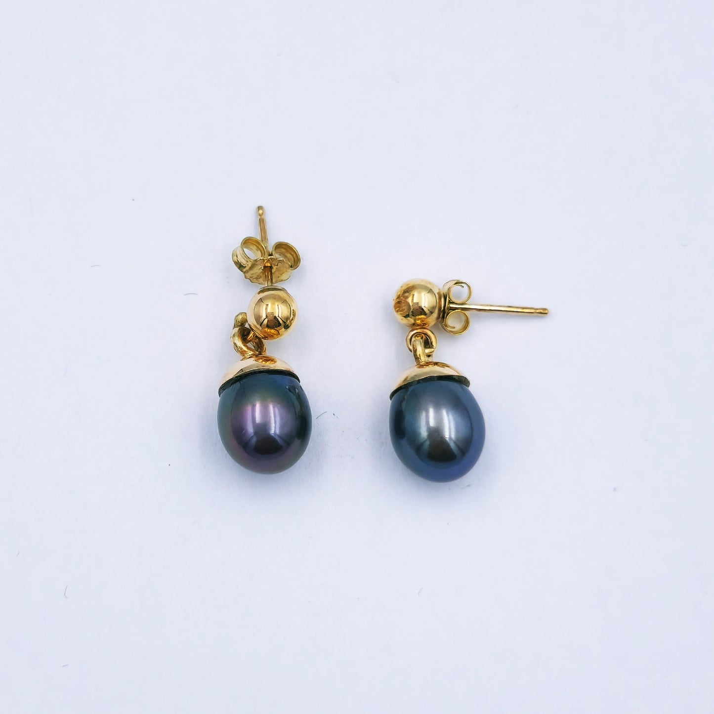 Pair of 9ct yellow gold dangle earrings with grey/brown oval pearls (9mm x 11mm) on lever-back hooks; total length approx. 2.8cm.