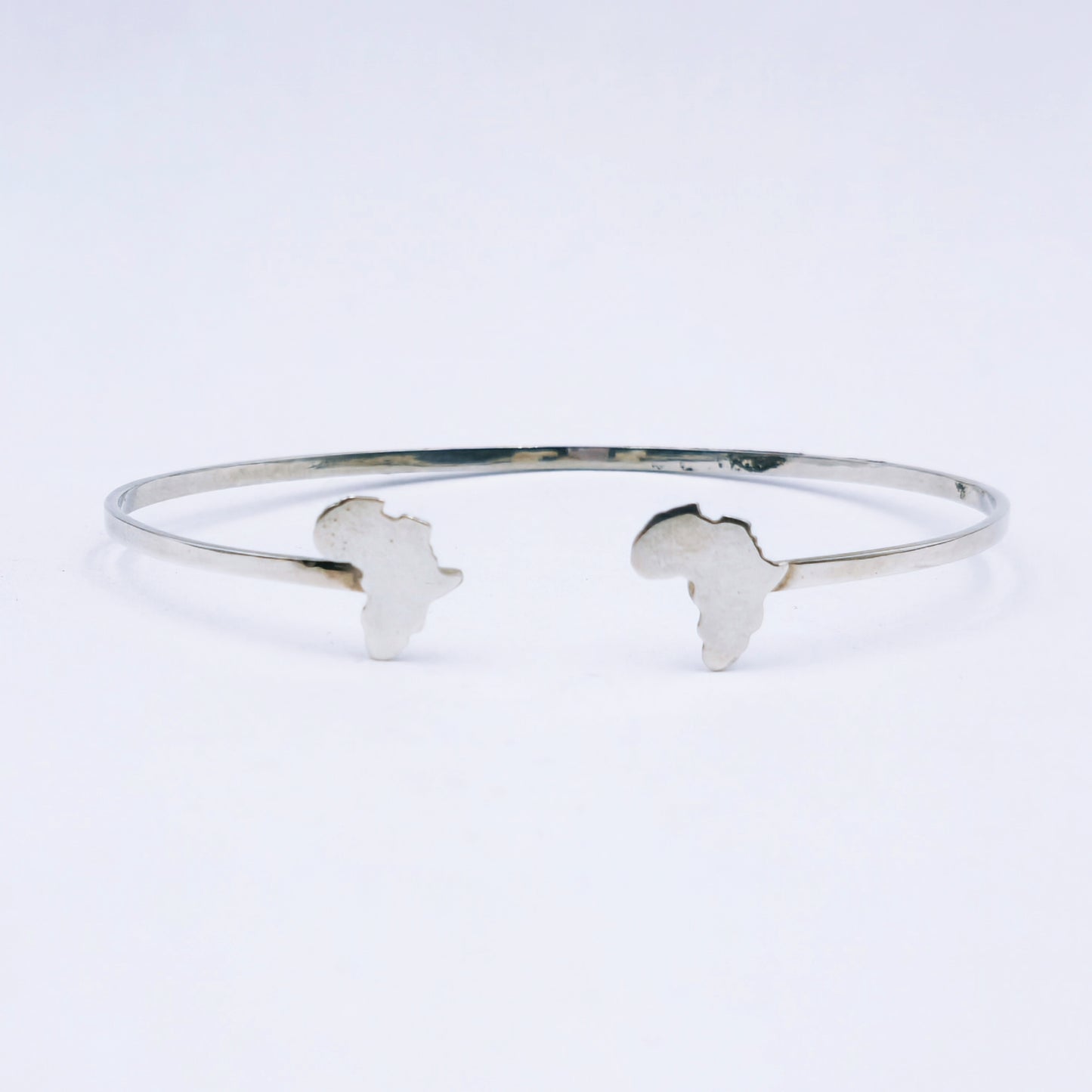 Sterling silver open bangle featuring cut-out Africa shapes at each end, 65mm adjustable diameter