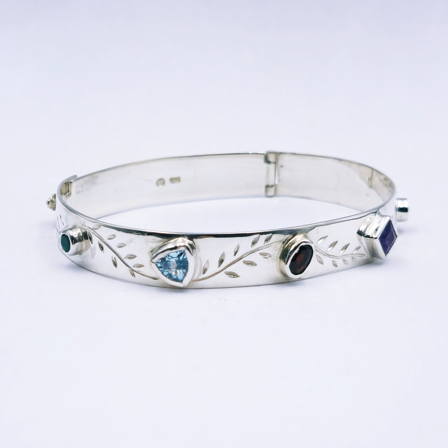 Repurposed vintage Scottish sterling silver bangle featuring a 15mm round light purple amethyst and Celtic detailing in a split band oval design.