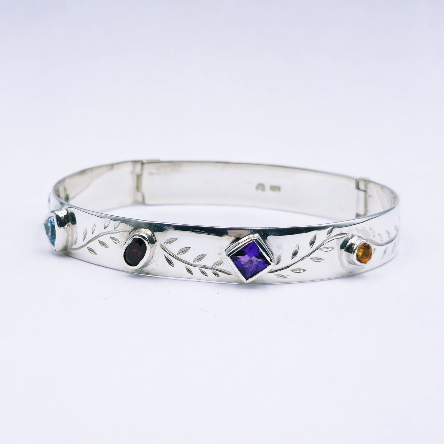 Repurposed vintage Scottish sterling silver bangle featuring a 15mm round light purple amethyst and Celtic detailing in a split band oval design.