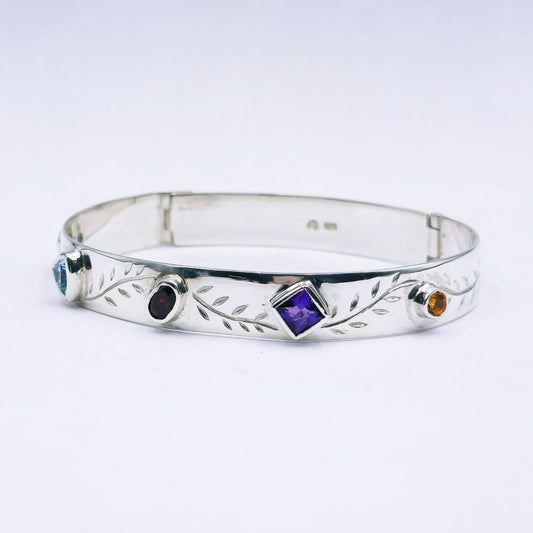 Repurposed vintage Scottish sterling silver bangle featuring a 15mm round light purple amethyst and Celtic detailing in a split band oval design.