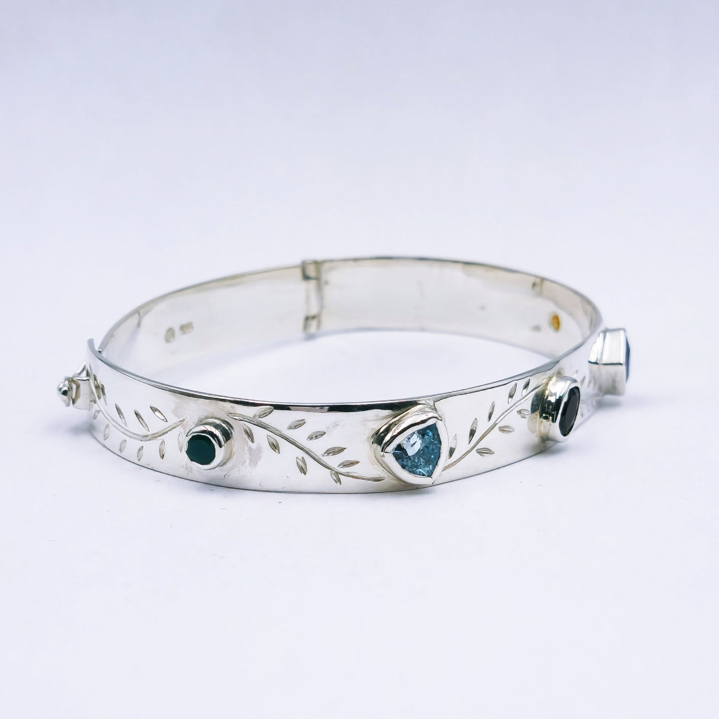 Repurposed vintage Scottish sterling silver bangle featuring a 15mm round light purple amethyst and Celtic detailing in a split band oval design.