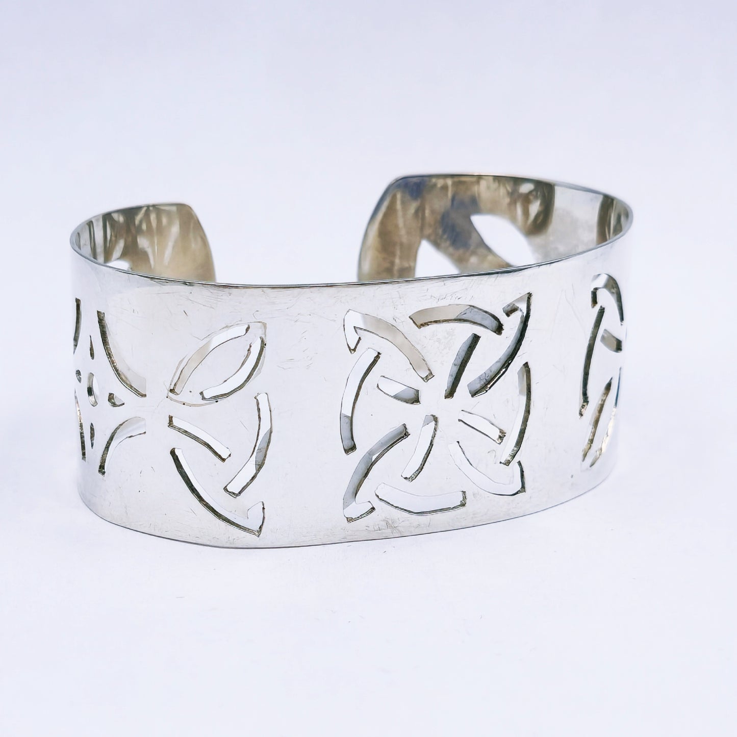 Handmade sterling silver wide cuff bangle with hand-pierced design, 28mm wide C-shaped bangle with a bold finish, 64mm diameter.