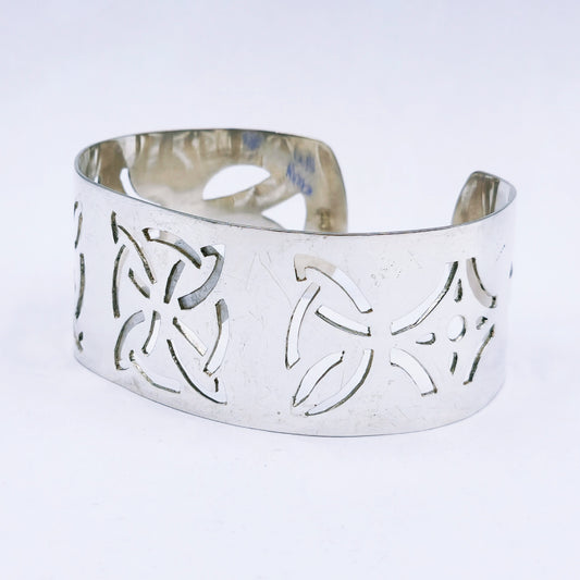 Handmade sterling silver wide cuff bangle with hand-pierced design, 28mm wide C-shaped bangle with a bold finish, 64mm diameter.