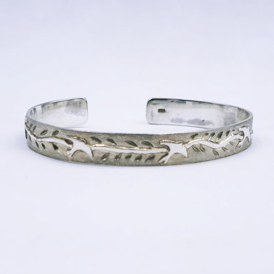 Sterling silver C-shape bangle featuring cut-out swallows and engraved leaves, handmade with 65mm diameter and 10mm width.