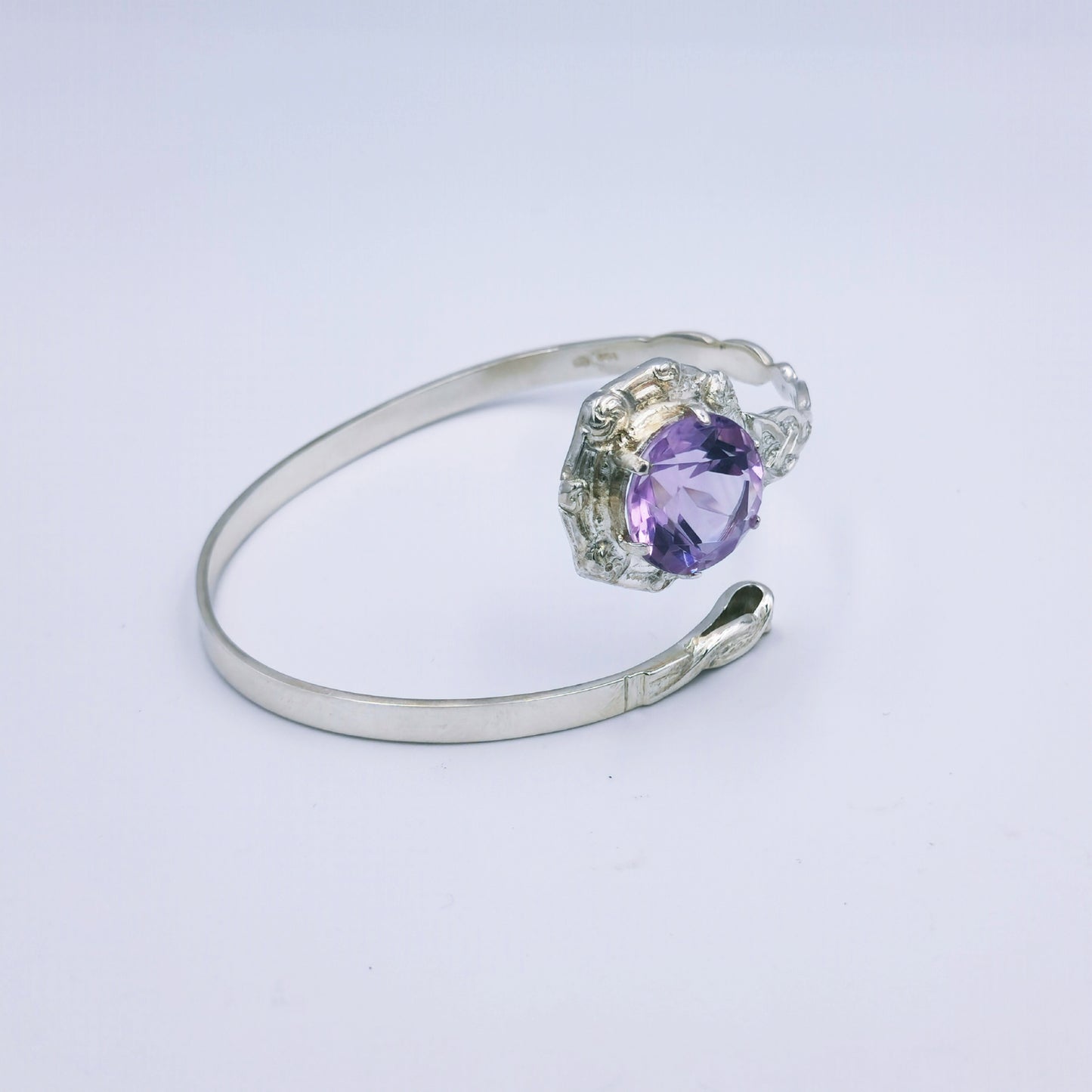 Repurposed vintage Scottish sterling silver bangle featuring a 15mm round light purple amethyst and Celtic detailing in a split band oval design.