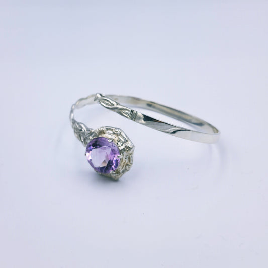 Repurposed vintage Scottish sterling silver bangle featuring a 15mm round light purple amethyst and Celtic detailing in a split band oval design.