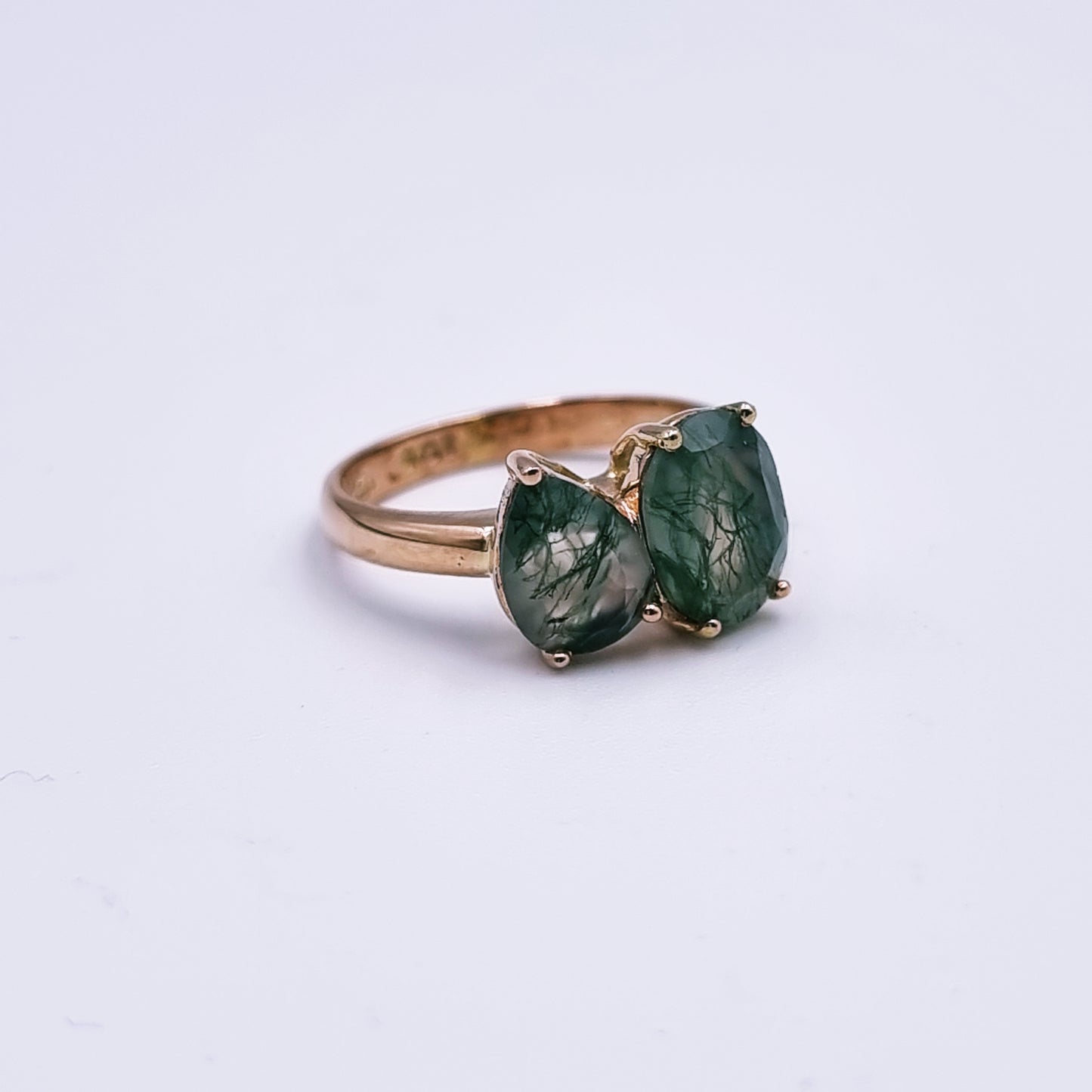 9ct rose gold ring featuring an oval (9mm x 7mm) and pear-shaped (8mm x 6mm) moss agate in a modern claw setting; total weight approx. 3.3g; Size M.