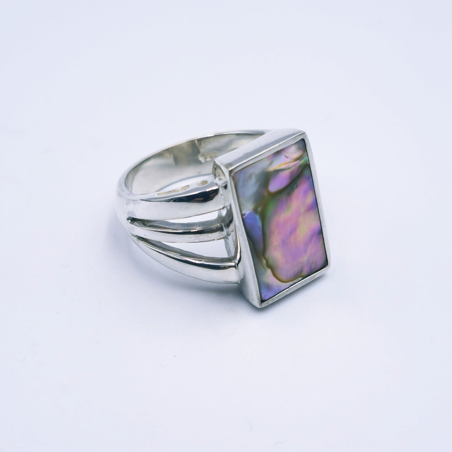 Three-band sterling silver ring featuring a rectangular abalone shell with rich iridescent tones, handmade and polished to a shine.