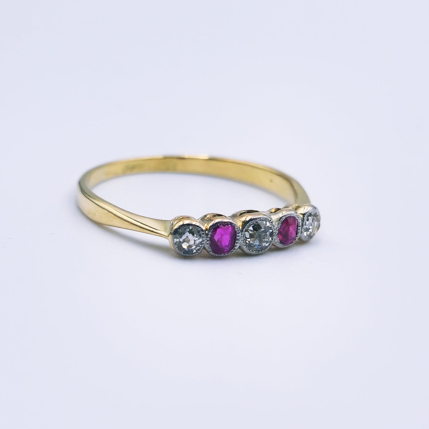 Preloved 18ct yellow gold ring with two rubies and three rose cut diamonds in an antique design.