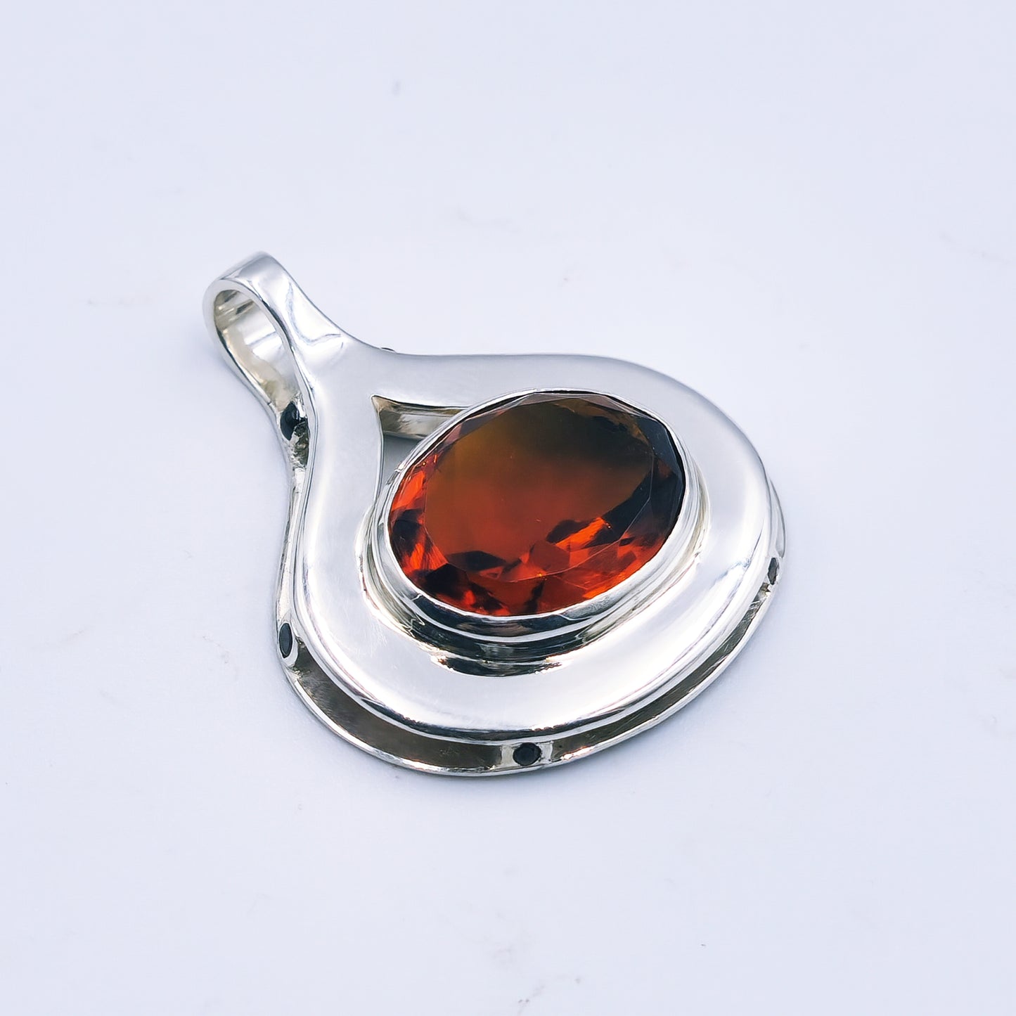 Sterling silver pendant with oval citrine and six garnets in a reinvented Scottish style.