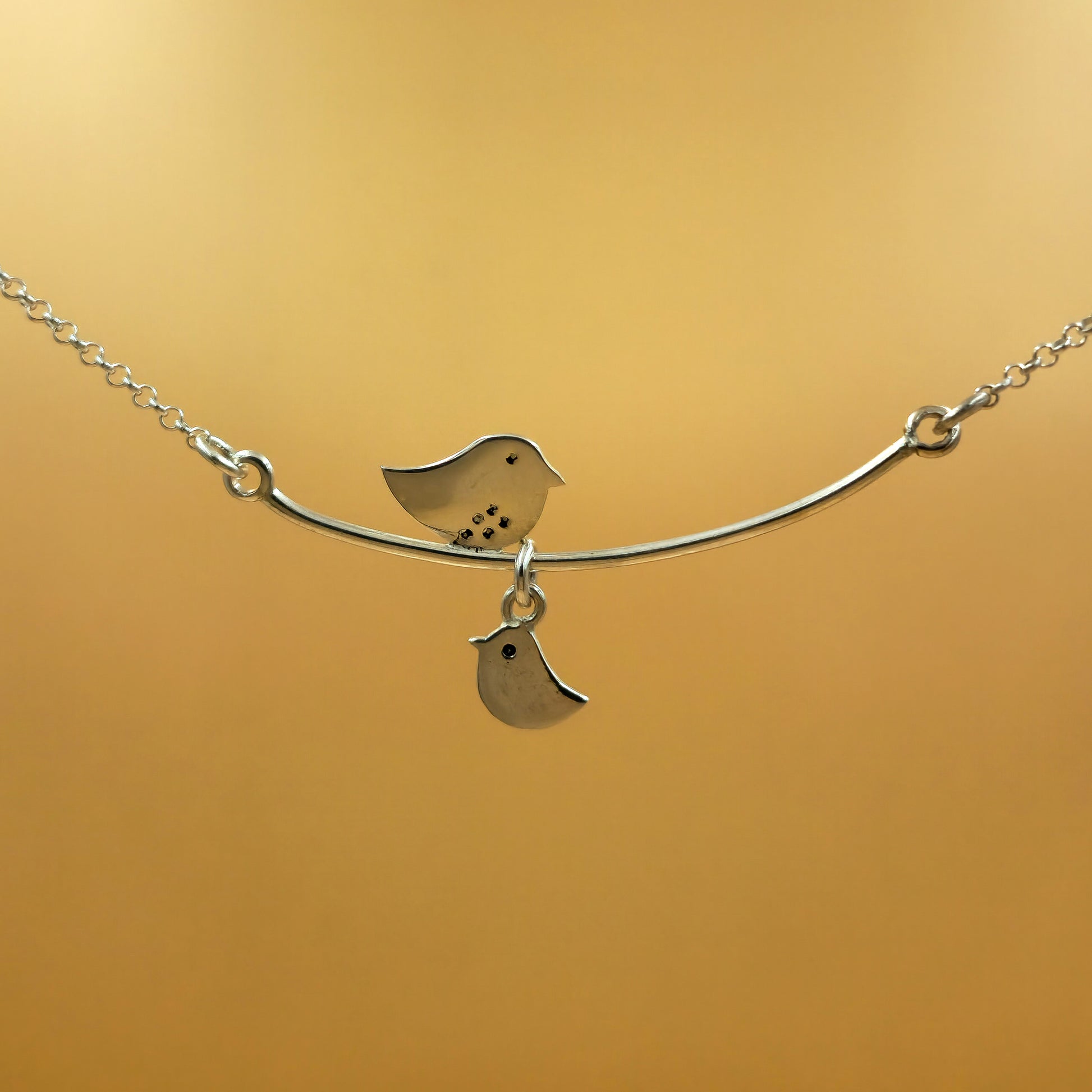 Sterling silver mommy necklace with a central fixed pendant and one baby chic charm on a 48cm chain, engravable initial option.