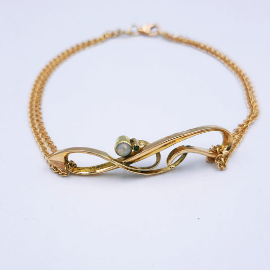 Restored Art Deco bracelet with 15ct rose gold panel set with a 3.5mm opal and 0.01ct emerald, attached to a delicate double strand 9ct rose gold chain; 19.5cm long, approx. 3.9g.