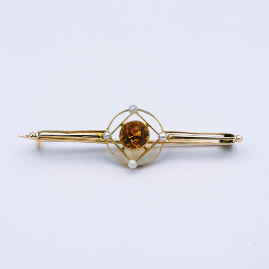 Antique brooch featuring a 6mm round citrine and seed pearls set in a 9ct yellow gold geometric frame, 4.6cm long x 12.5mm wide; tested gold, in original box.