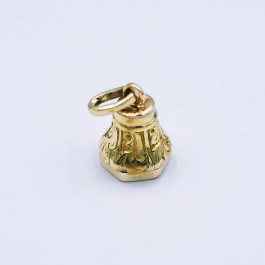 Restored 9ct yellow gold miniature fob seal pendant with curved scroll design and hexagonal base featuring a round mother of pearl inlay; approx. 14mm high x 10.5mm wide, 3.8g.
