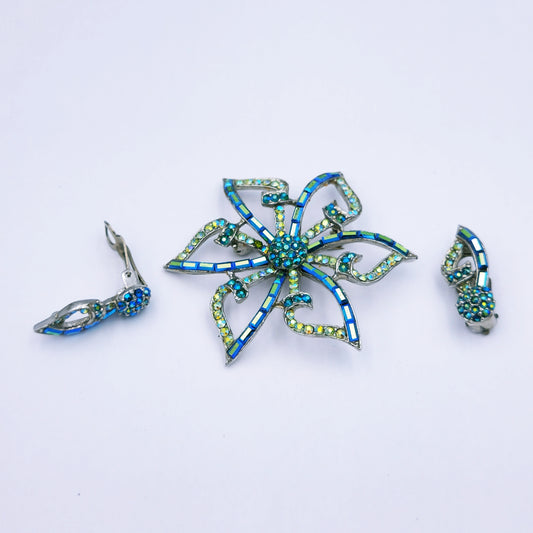 Blue and silver costume jewellery set featuring a 5.5cm alloy flower brooch with matching clip-on earrings, presented in its original vintage box.


