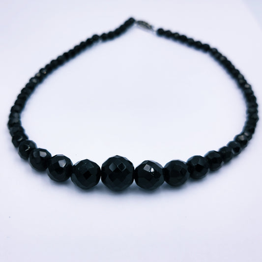 Vintage 43cm necklace with faceted black onyx beads tapering from 14mm to 5.5mm, finished with a vintage marcasite-accented clasp