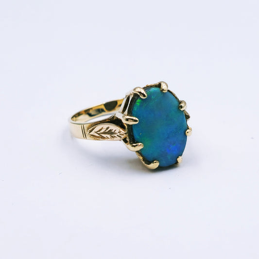 9ct yellow gold ring featuring a 13.5mm x 10mm oval opal doublet in a claw setting with scalloped surround, ring size Q, approx. 4.4g.