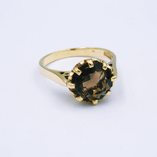 9ct yellow gold ring featuring a 10mm round smokey quartz in an eight-claw setting with pierced side detail, ring size O, approx. 3.7g