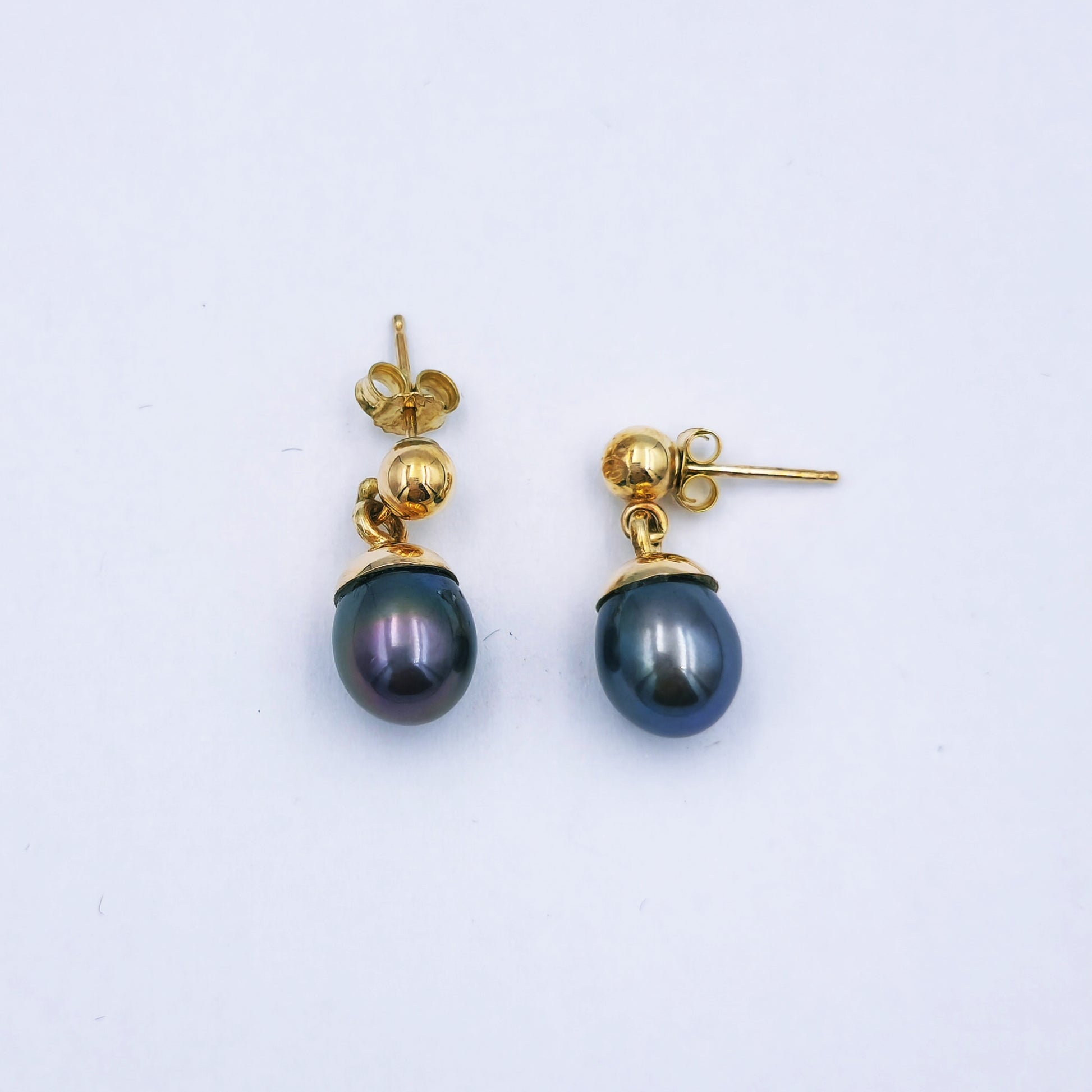 Pair of 9ct yellow gold dangle earrings with grey/brown oval pearls (9mm x 11mm) on lever-back hooks; total length approx. 2.8cm.
