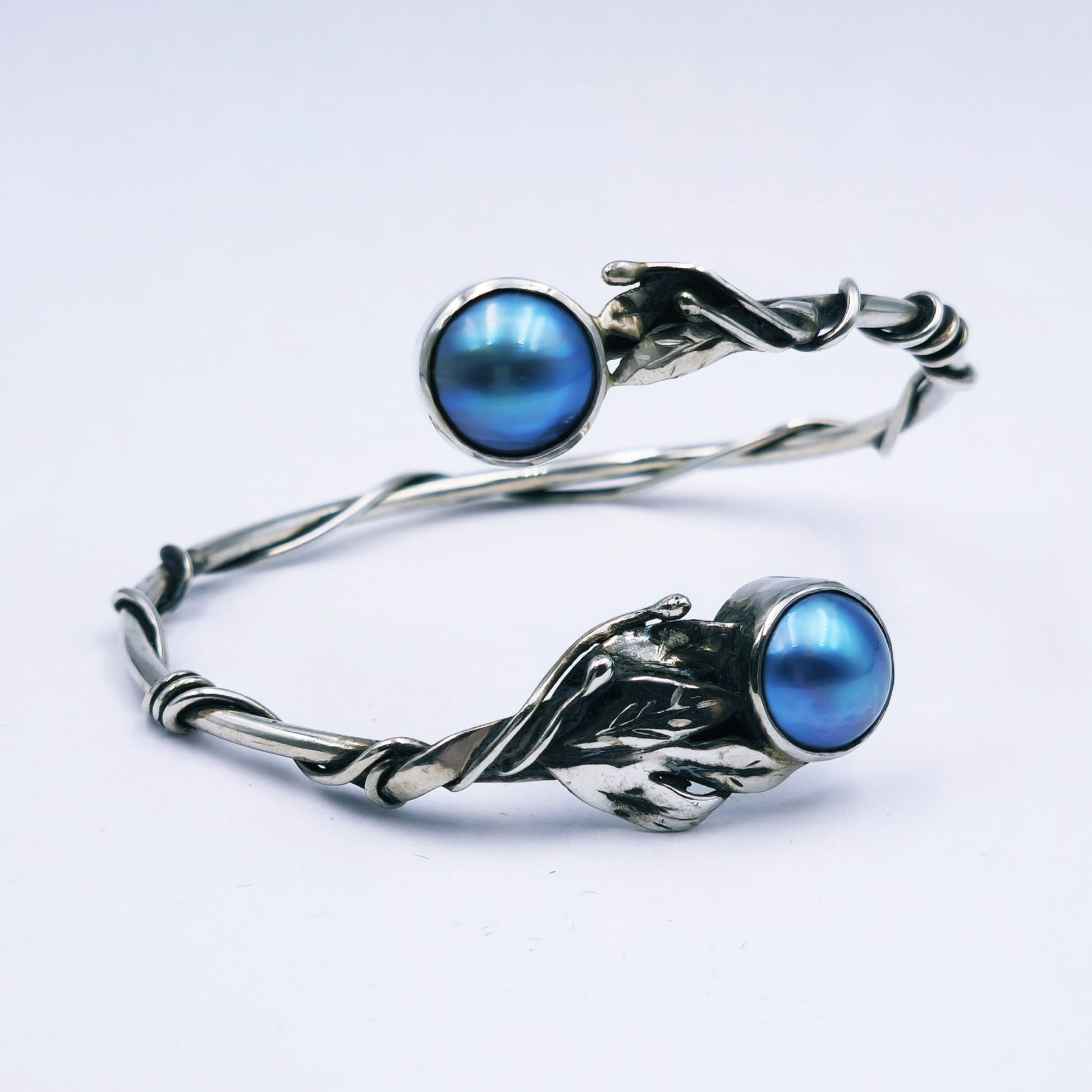 Handmade sterling silver bangle with two blue/grey mabe pearls and decorative leaf and stalk design, solid 3mm round bangle, 65mm diameter.