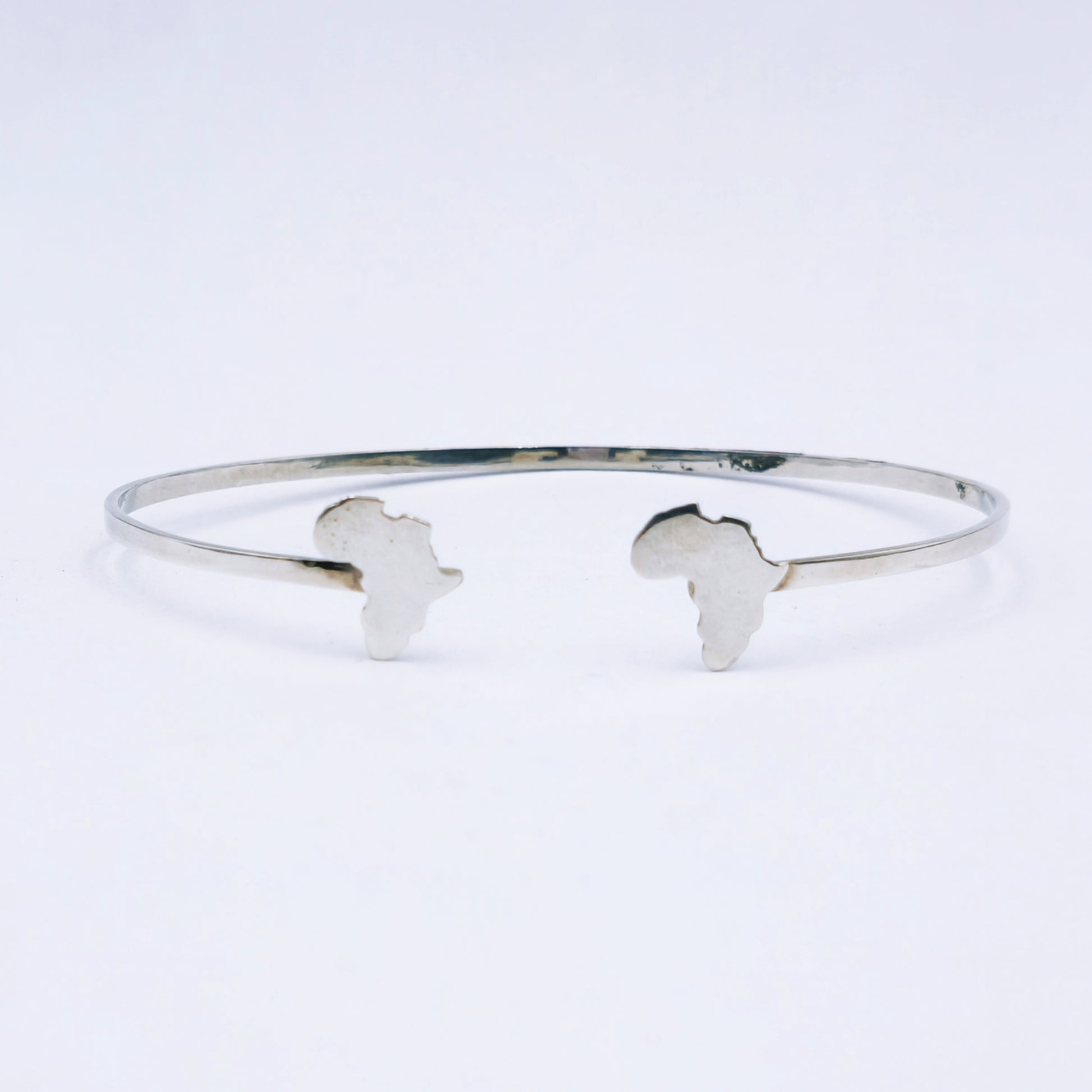 Sterling silver open bangle featuring cut-out Africa shapes at each end, 65mm adjustable diameter