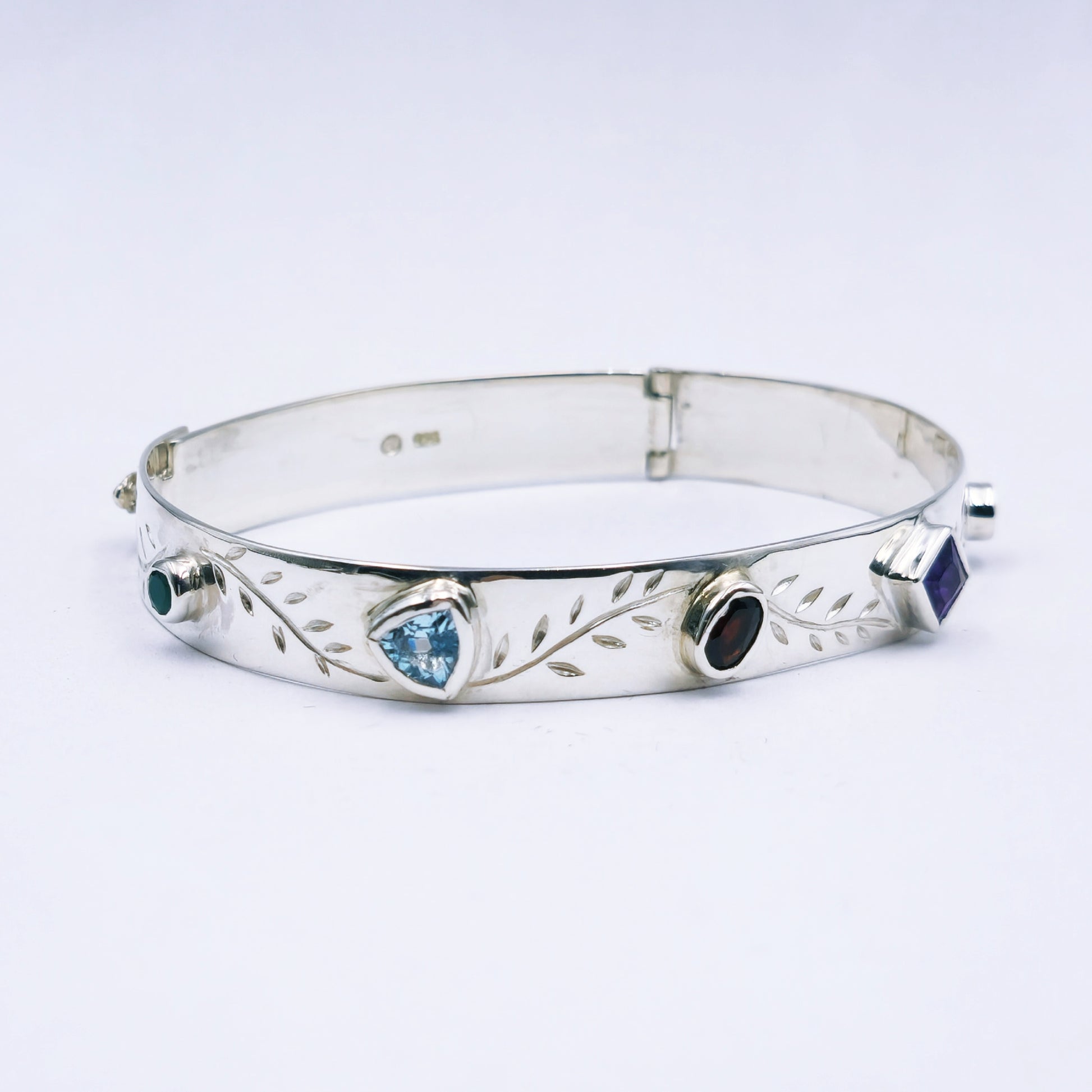Repurposed vintage Scottish sterling silver bangle featuring a 15mm round light purple amethyst and Celtic detailing in a split band oval design.