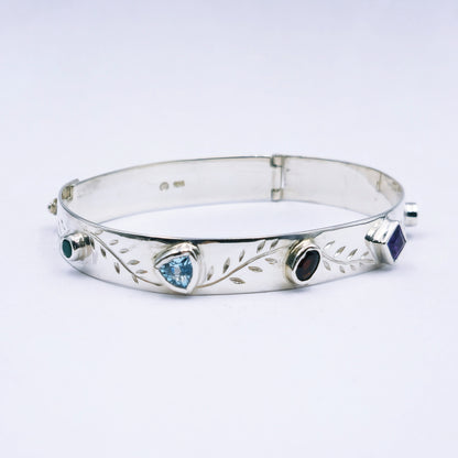 Repurposed vintage Scottish sterling silver bangle featuring a 15mm round light purple amethyst and Celtic detailing in a split band oval design.