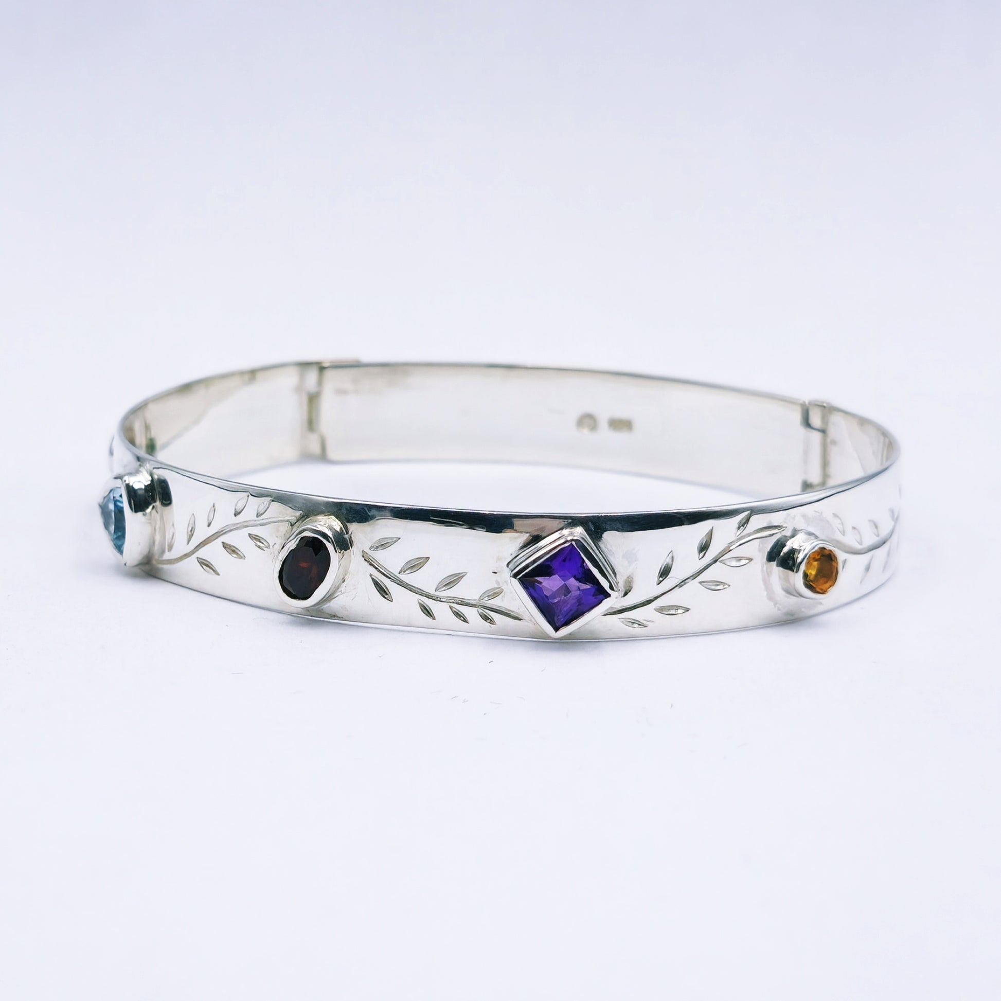 Repurposed vintage Scottish sterling silver bangle featuring a 15mm round light purple amethyst and Celtic detailing in a split band oval design.