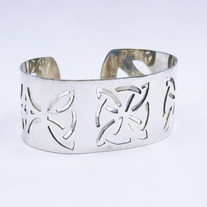 Handmade sterling silver wide cuff bangle with hand-pierced design, 28mm wide C-shaped bangle with a bold finish, 64mm diameter.