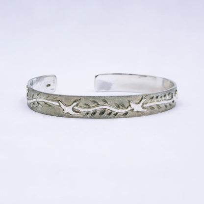 Sterling silver C-shape bangle featuring cut-out swallows and engraved leaves, handmade with 65mm diameter and 10mm width.