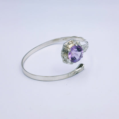 Repurposed vintage Scottish sterling silver bangle featuring a 15mm round light purple amethyst and Celtic detailing in a split band oval design.
