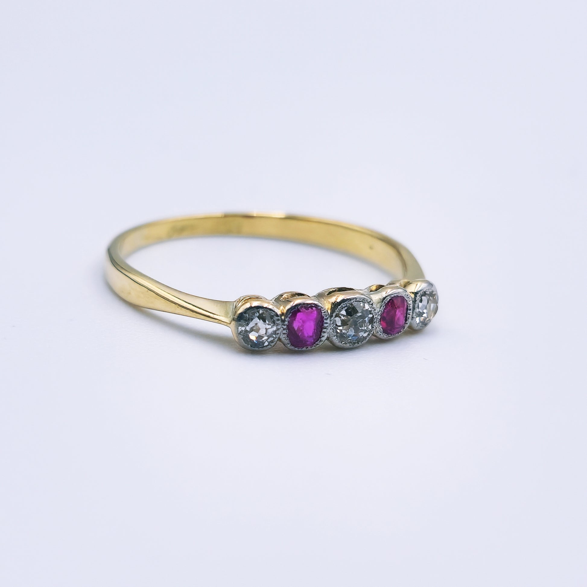 Preloved 18ct yellow gold ring with two rubies and three rose cut diamonds in an antique design.