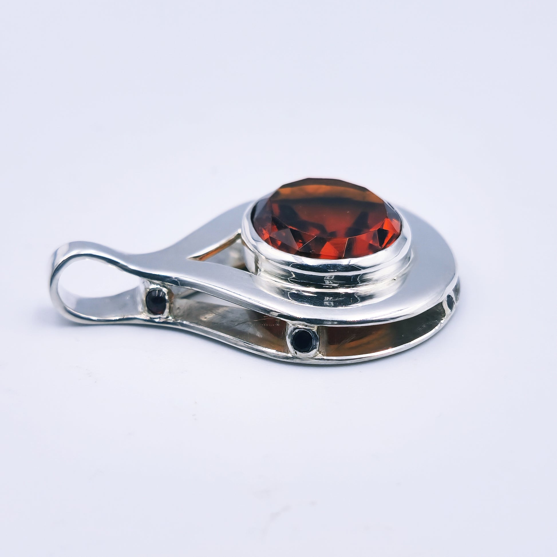Sterling silver pendant with oval citrine and six garnets in a reinvented Scottish style.