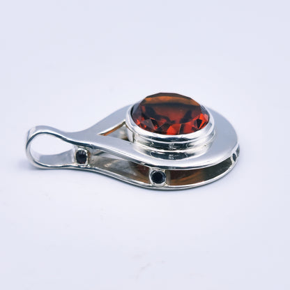 Sterling silver pendant with oval citrine and six garnets in a reinvented Scottish style.